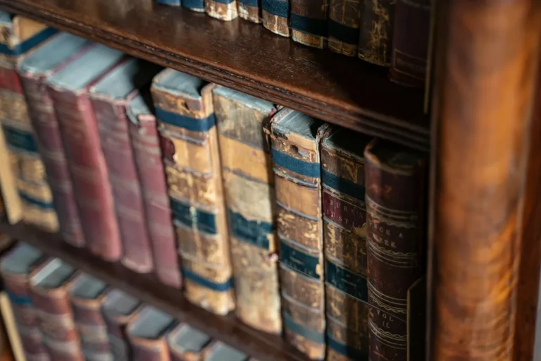 A 19th-century deck of Russian playing cards on a literary library desk